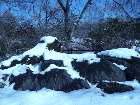 Humans huddle in a gazebo under an icy blue sky Snow drapes this 